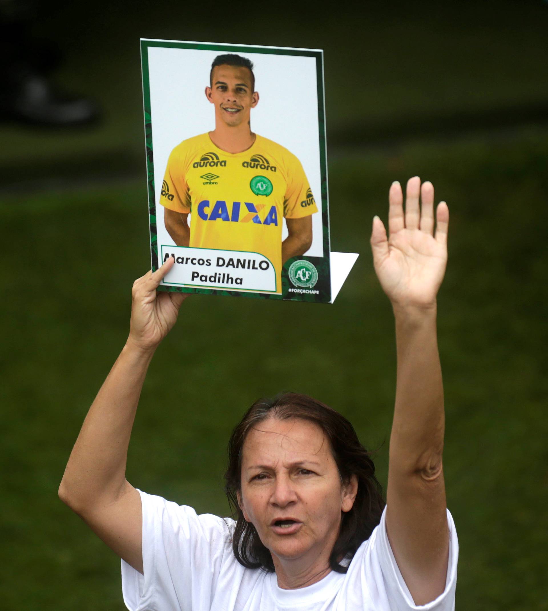 Alaide, mother of Chapecoense goalkeeper Danilo holds a picture of her son who was a victim of the plane crash in Colombia, after a ceremony to pay tribute to Chapecoense players at Arena Conda stadium in Chapeco