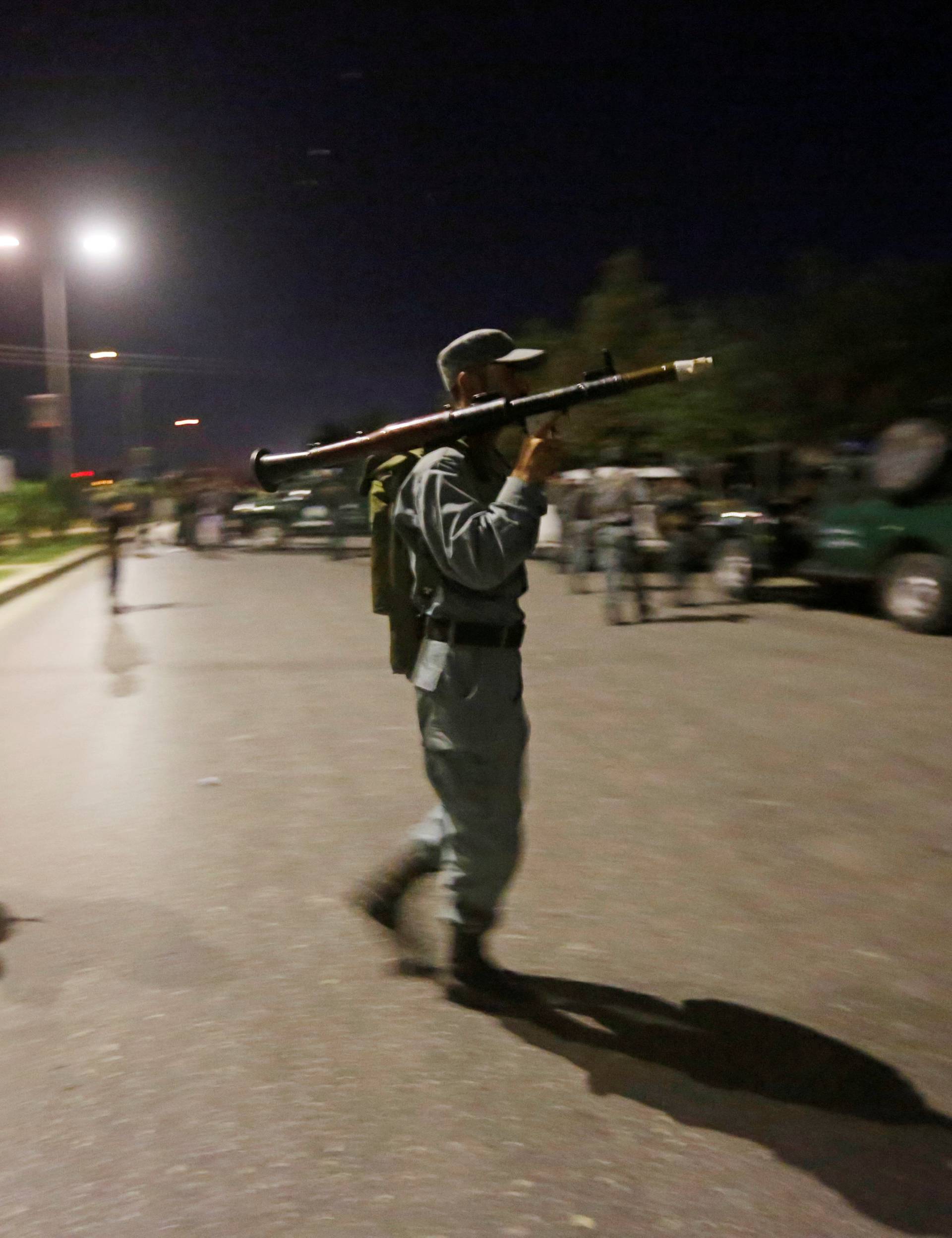 Afghan policemen stand guard at the site of an attack at American University of Afghanistan in Kabul