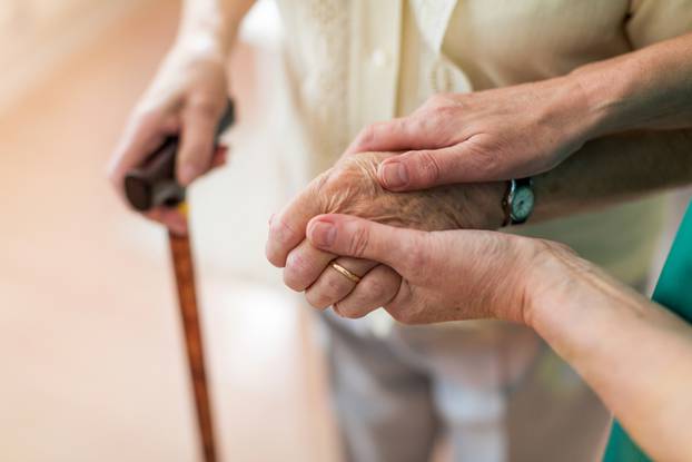 Nurse,Consoling,Her,Elderly,Patient,By,Holding,Her,Hands