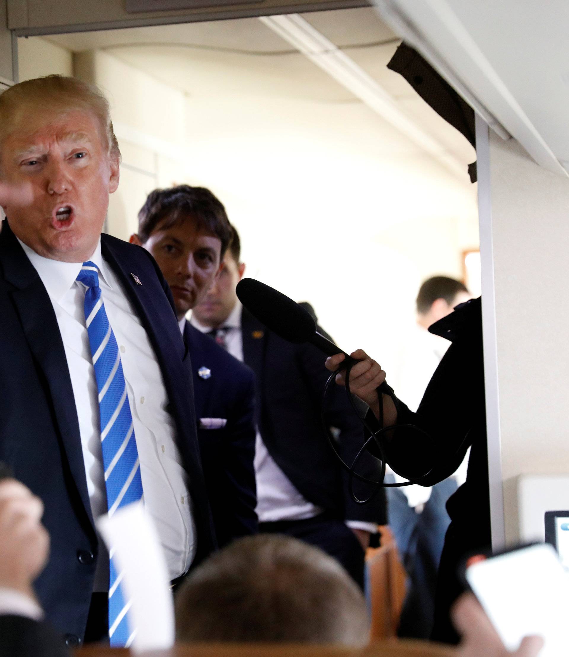 U.S. President Donald Trump speaks aboard Air Force One