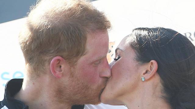 Britain's Prince Harry kisses his wife Meghan the Duchess of Sussex after a charity polo match in Windsor