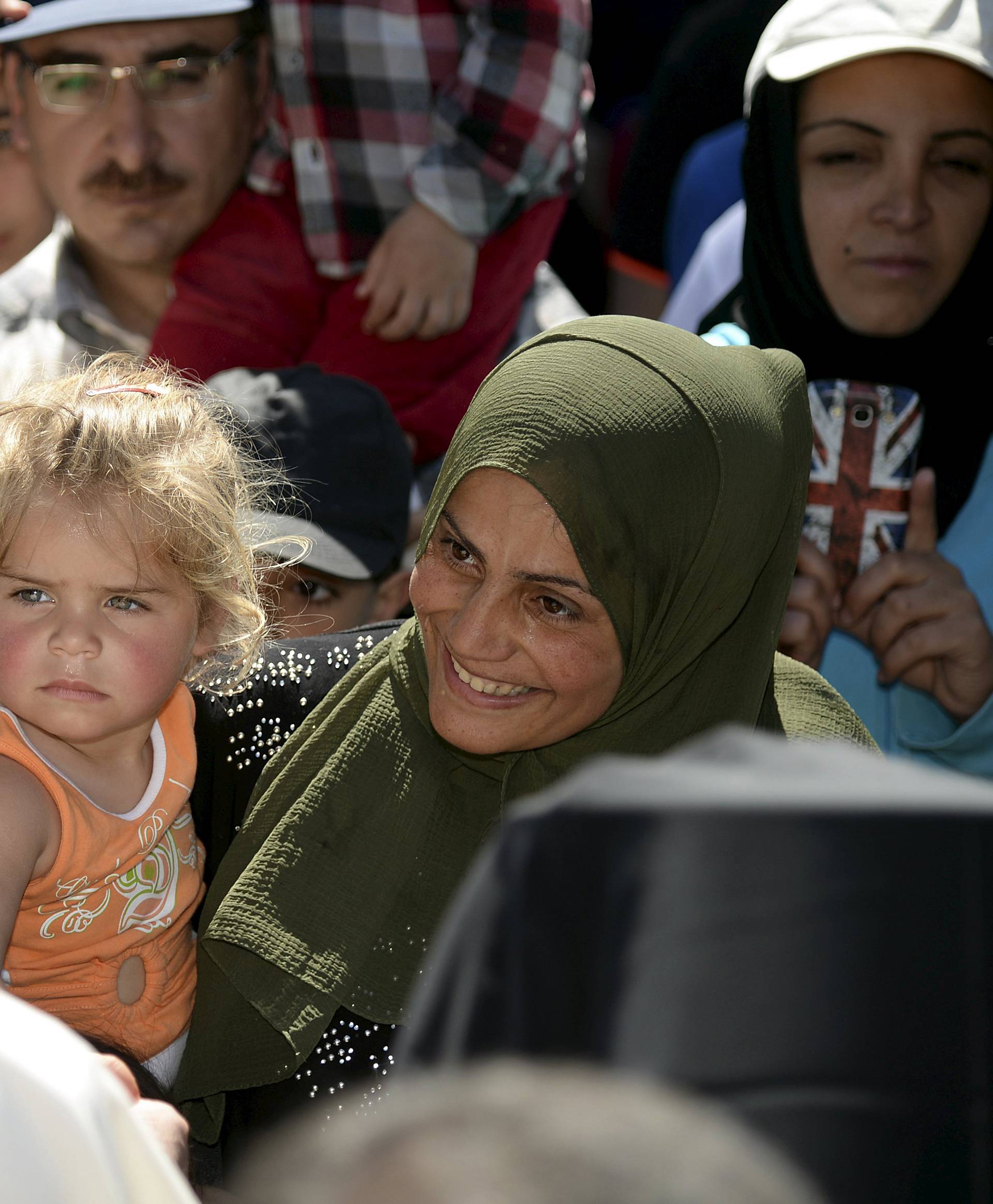 Pope Francis greets migrants and refugees at the Moria refugee camp near the port of Mytilene, on the Greek island of Lesbos 