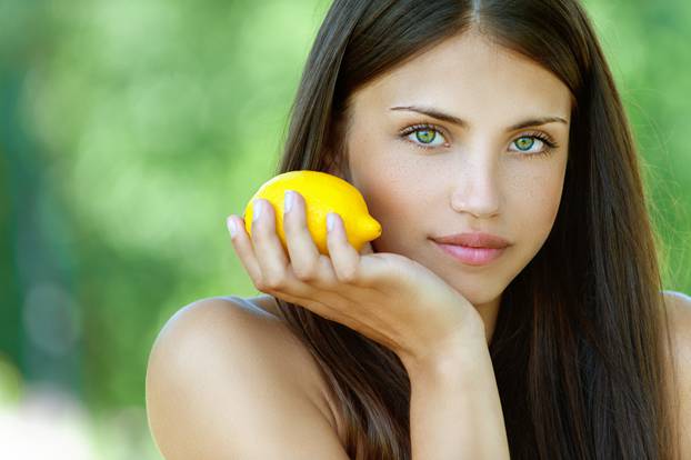 young woman with yellow lemon