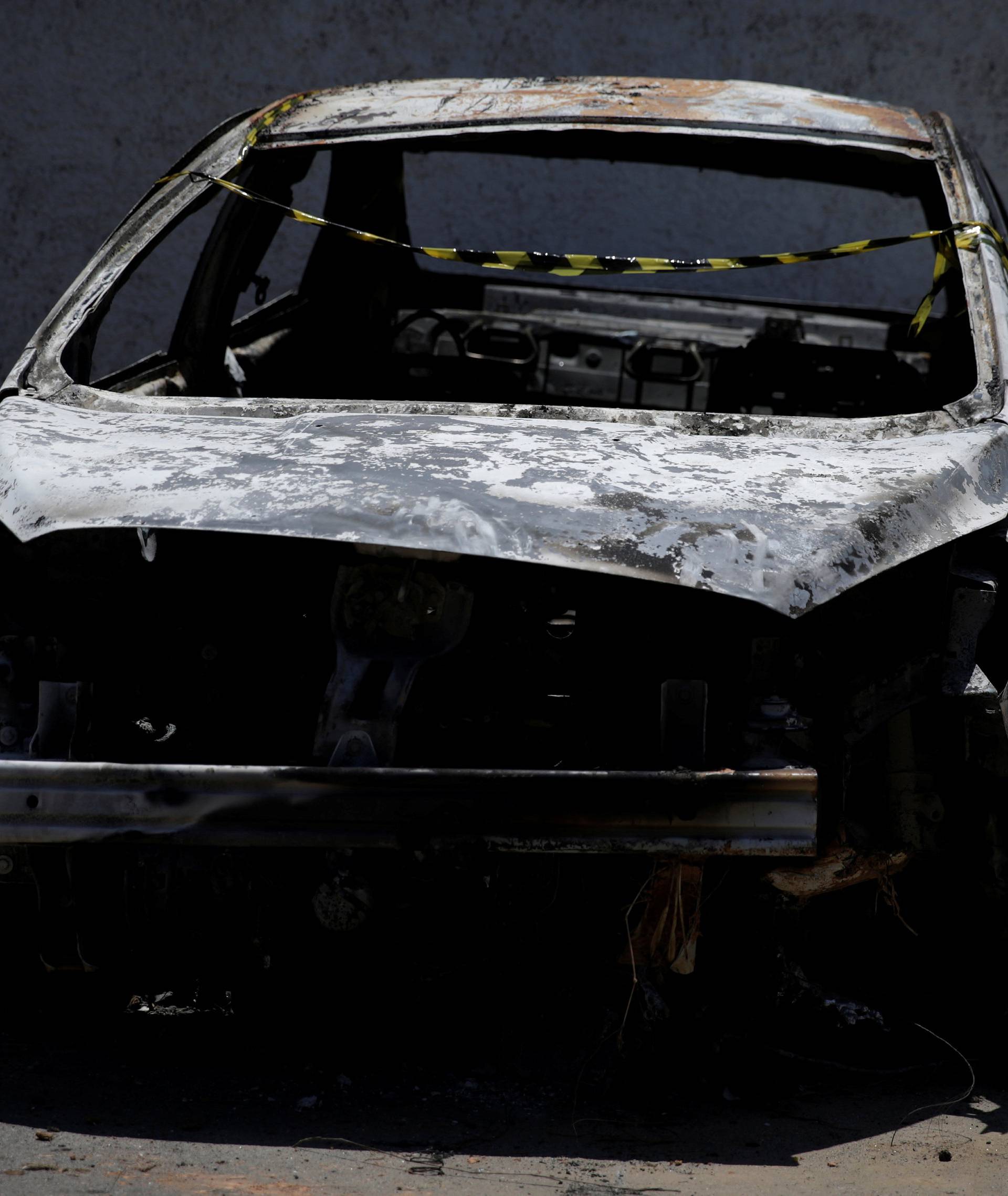 A burned car in which a body was found during searches for the Greek Ambassador for Brazil Kyriakos Amiridis, is pictured at a police station in Belford Roxo