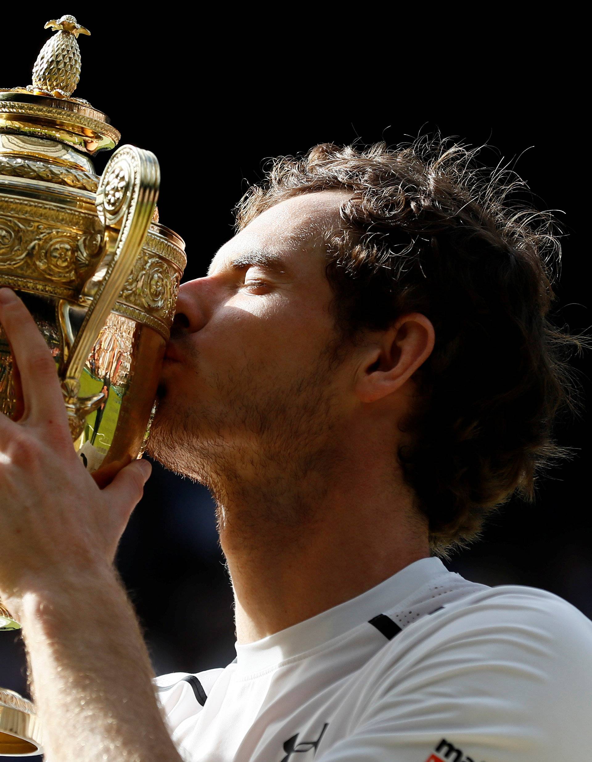 FILE PHOTO: Britain's Andy Murray kisses the Wimbledon trophy at All England Lawn Tennis & Croquet Club, Wimbledon, England - 10/7/16