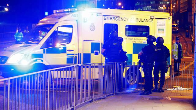 Armed police officers stand near the Manchester Arena, where U.S. singer Ariana Grande had been performing, in Manchester, in northern England, Britain