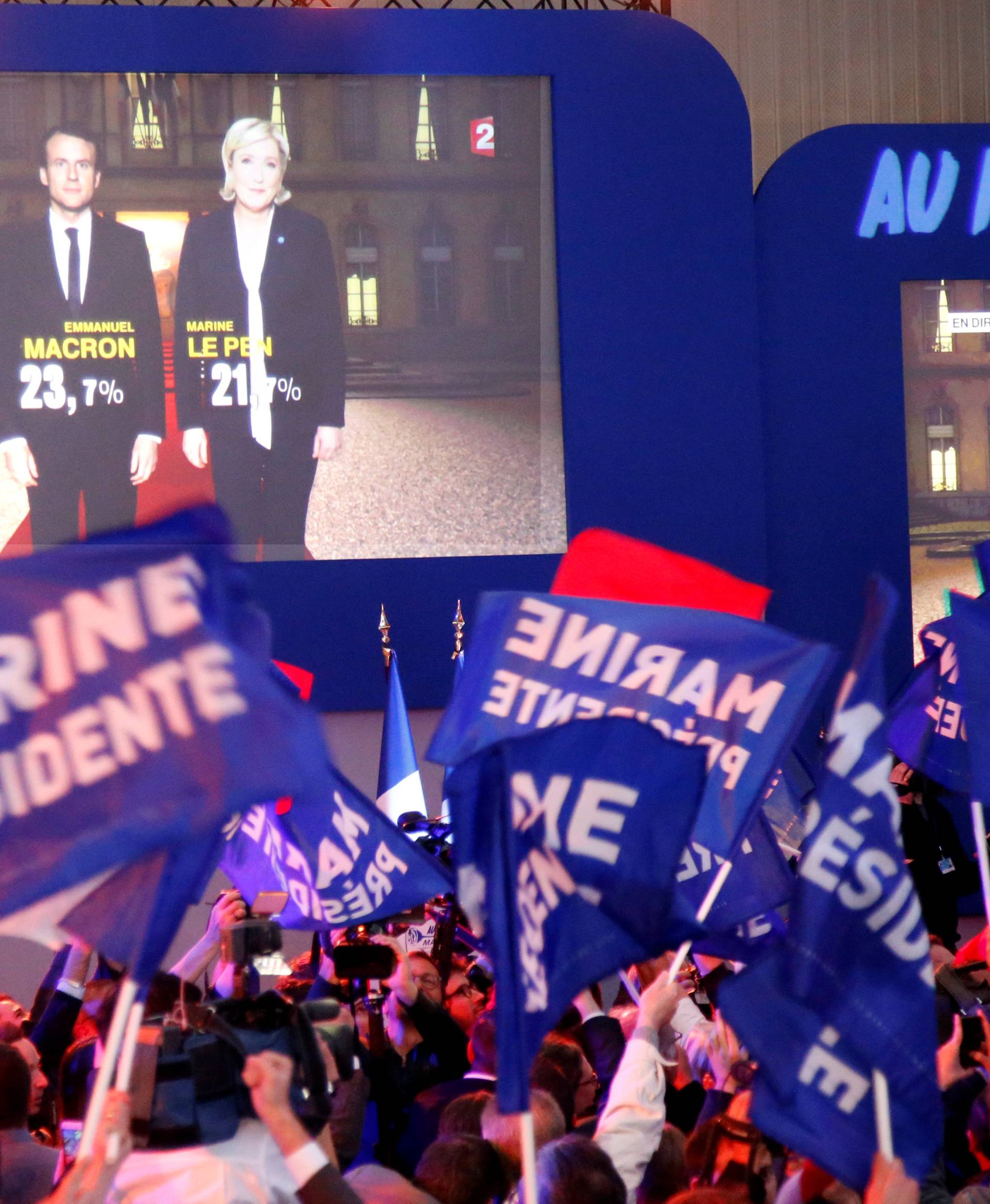 Supporters of Marine Le Pen, French National Front (FN) political party leader and candidate for French 2017 presidential election, react in Henin-Beaumont
