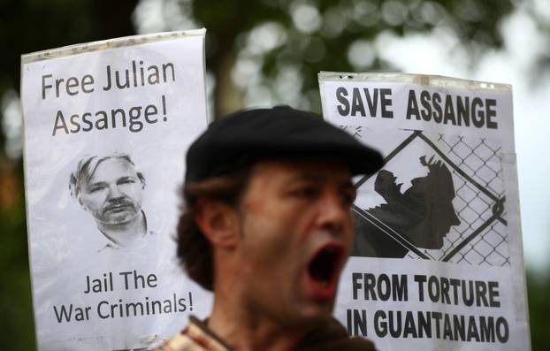 A demonstrator protests outside of Westminster Magistrates Court, where a case hearing for U.S. extradition of Wikileaks founder Julian Assange is held, in London