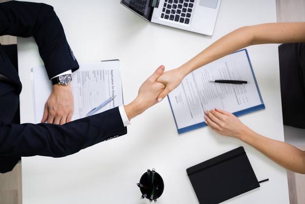 Portrait,Of,Two,Happy,Businesswoman,Having,Handshake,In,Office