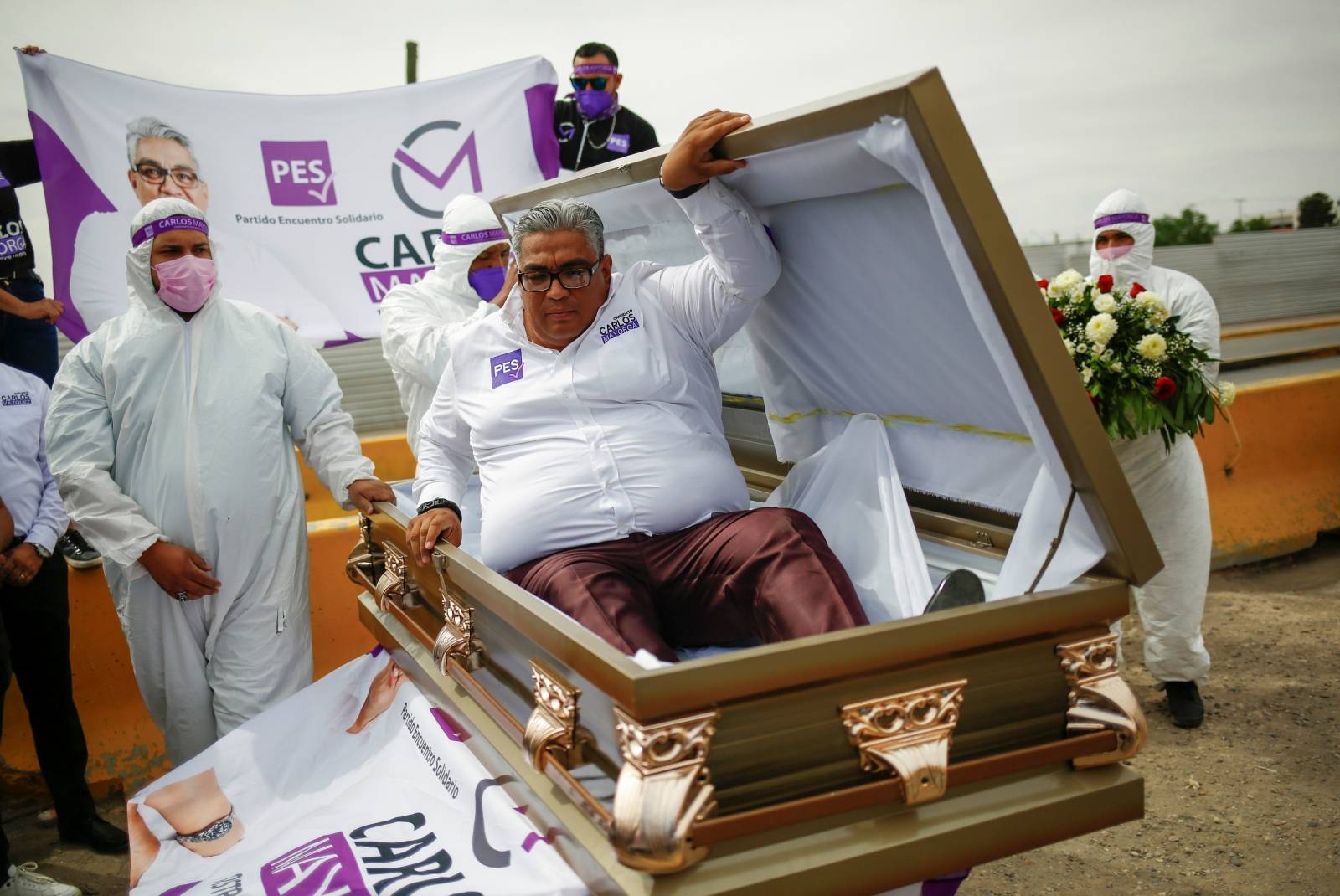 Carlos Mayorga, Mexican candidate for federal representative, emerges from a coffin as part of his campaign slogan "If I don't deliver, let them bury me alive" near the Zaragoza-Ysleta international border bridge, in Ciudad Juarez
