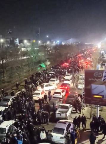People gather on the streets during a protest in Mashhad