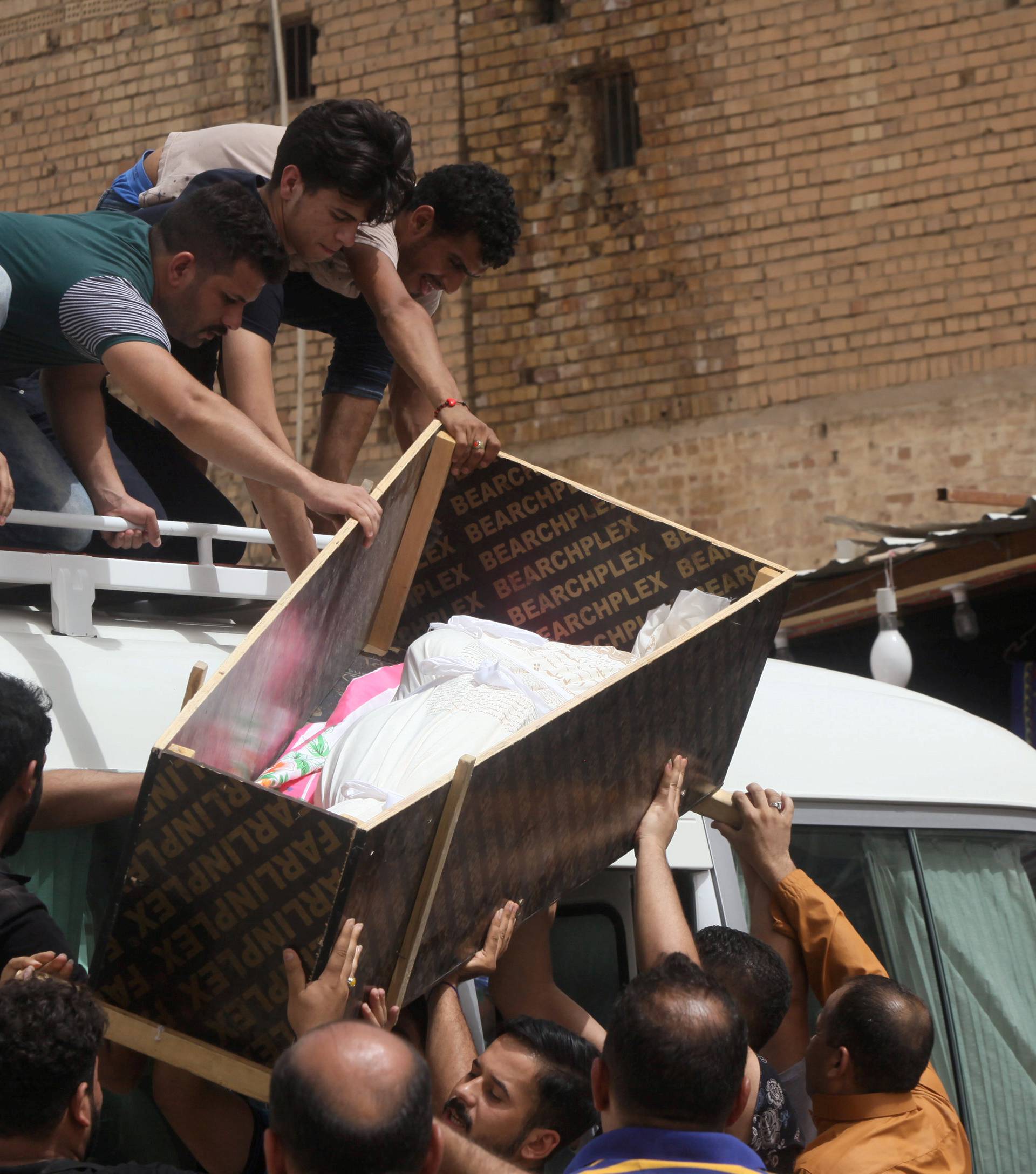 Mourners carry the coffin of their relative, who was killed in a suicide vehicle bomb in the Karrada shopping area in Baghdad, during the funeral in Najaf