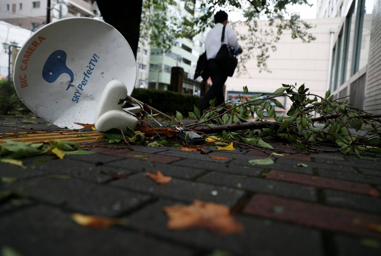 A satellite broadcast television receiving antenna, which was blown away by strong winds caused by Typhoon Faxai, is seen on a street in Tokyo