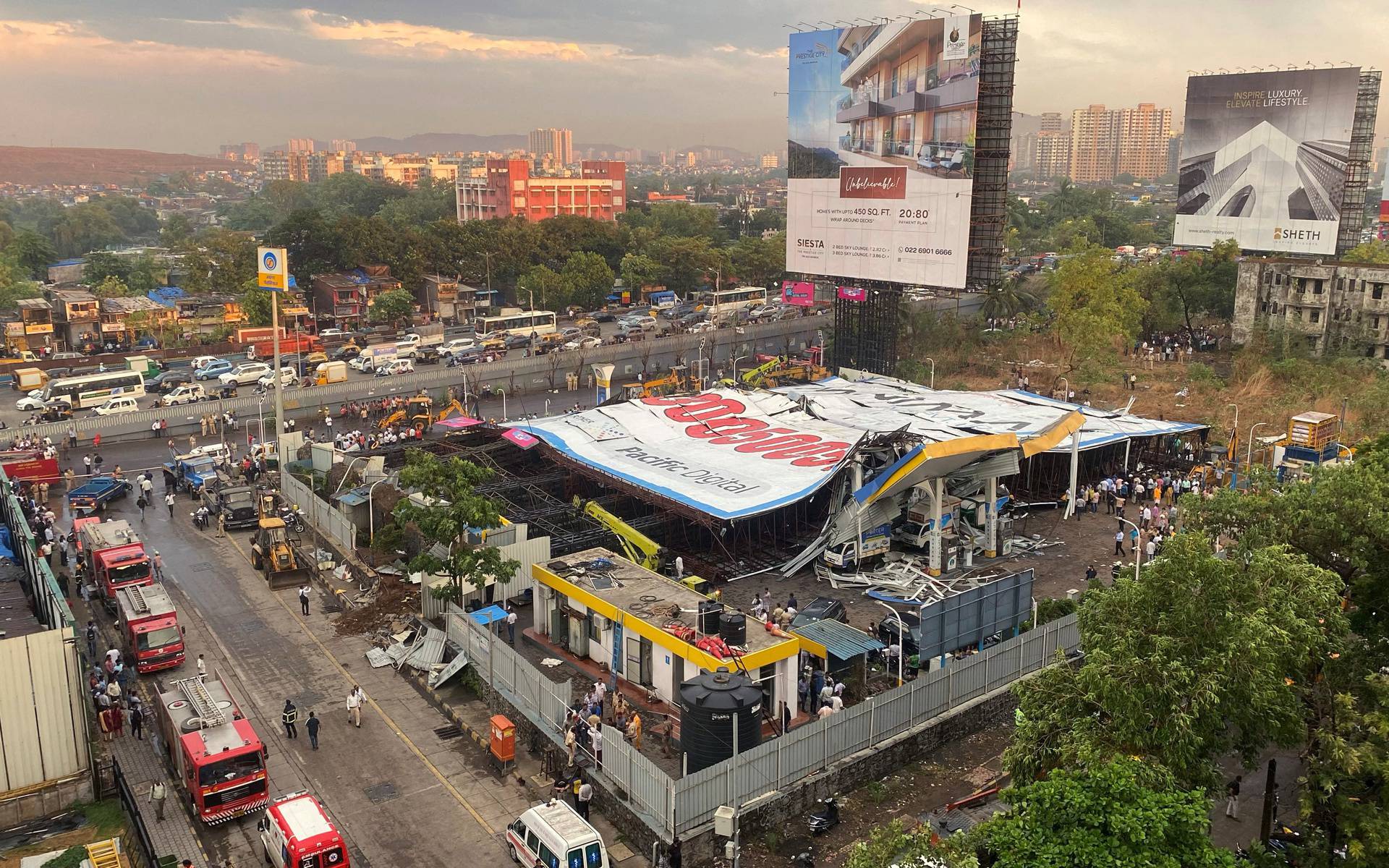 An aerial view shows a fallen billboard on a fuel station following a wind and dust storm in Mumbai