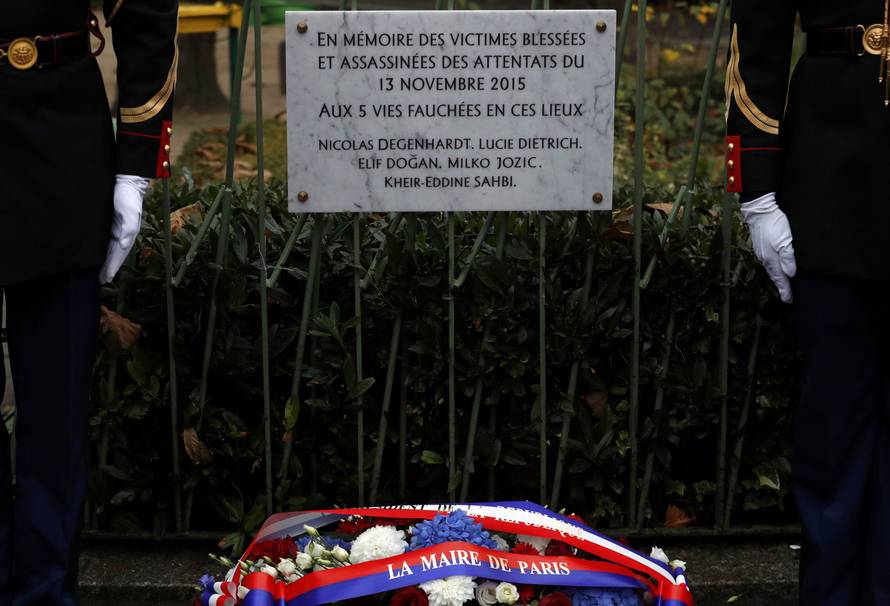 French President Francois Hollande and Paris Mayor Anne Hidalgo unveil a commemorative plaque next to the "A La Bonne Biere" cafe