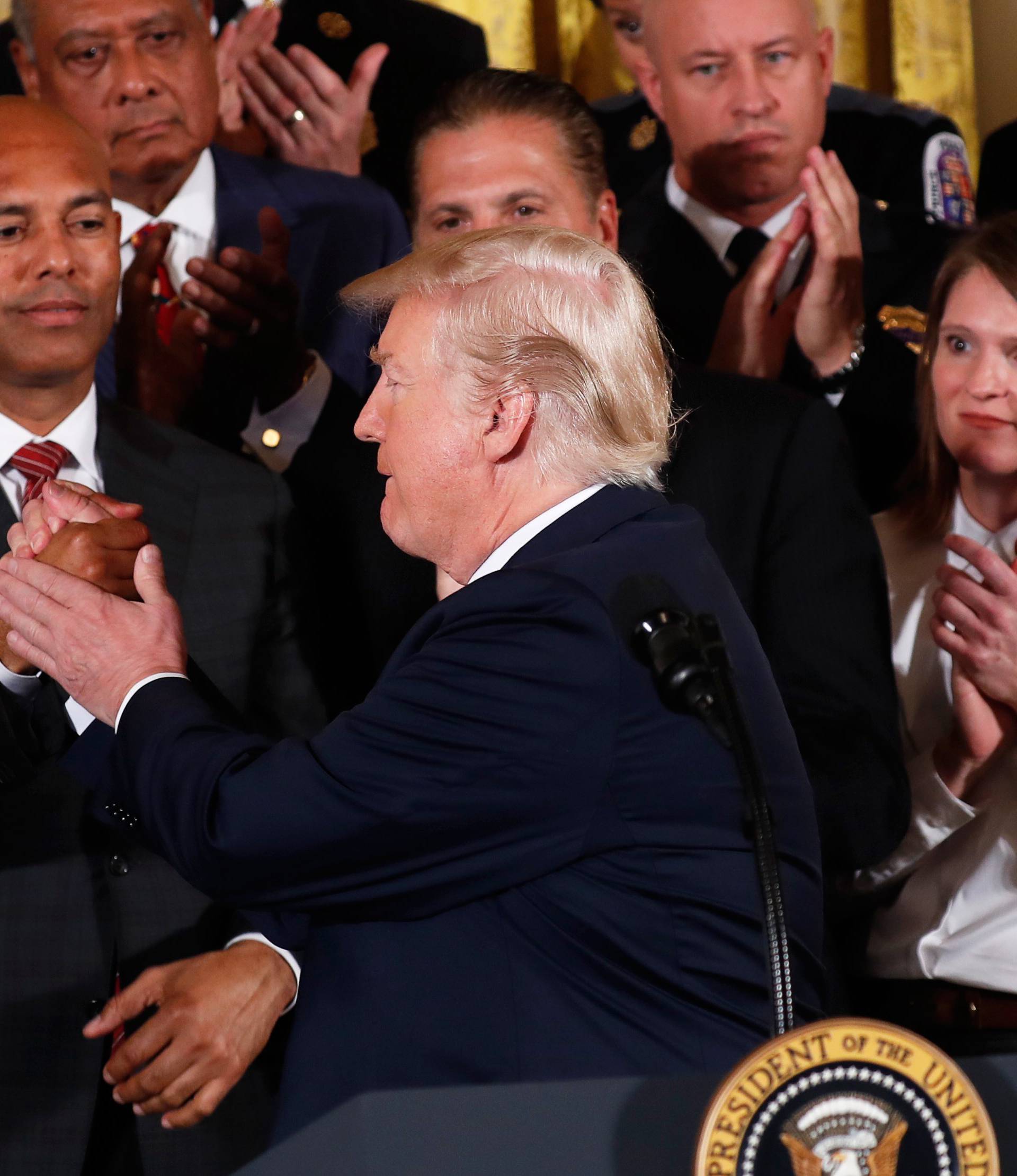 U.S. President Donald Trump greets former New York Yankees pitcher Mariano Rivera before he speaks about administration plans to combat the nation's opioid crisis in the East Room of the White House in Washington