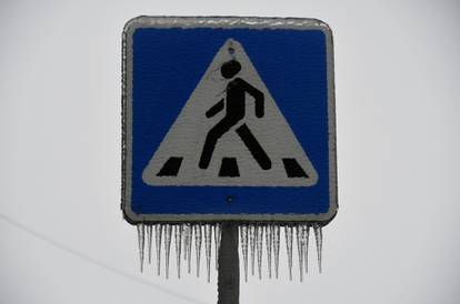 An ice covered road sign is pictured after freezing rain in the far eastern city of Vladivostok