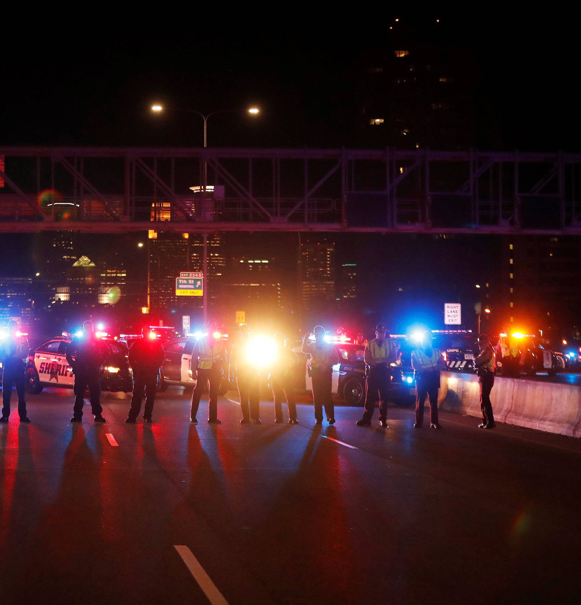 Police keep watch as demonstrators protest against President-elect Donald Trump in Minneapolis