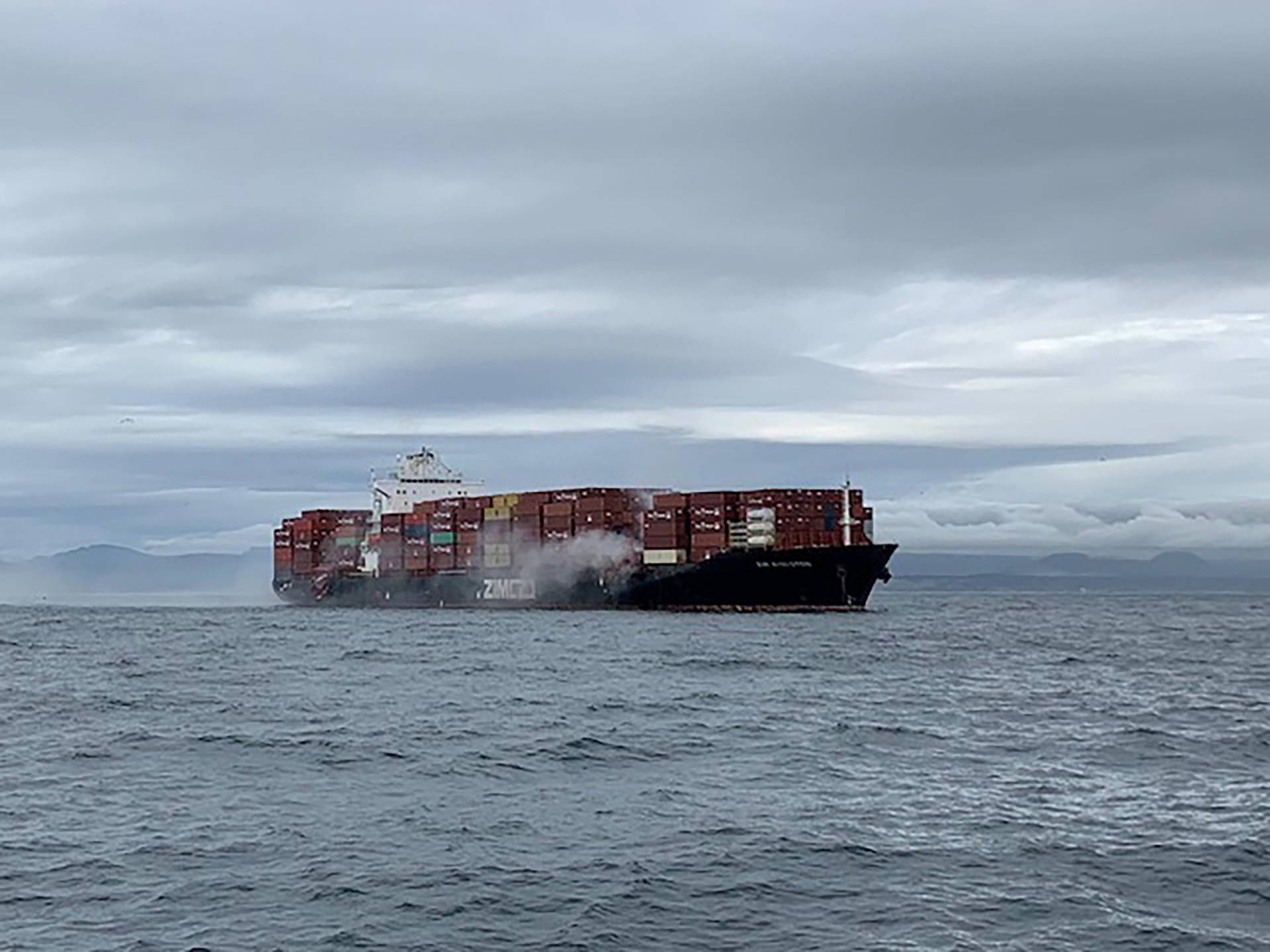 The container ship Zim Kingston burns from a fire off the coast of Victoria