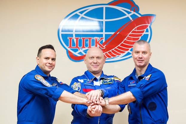 Crew members attend a news conference ahead of the expedition to the International Space Station at the Baikonur Cosmodrome