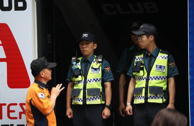 Police secure the area outside a night club after its upper floor collapsed in Gwangju