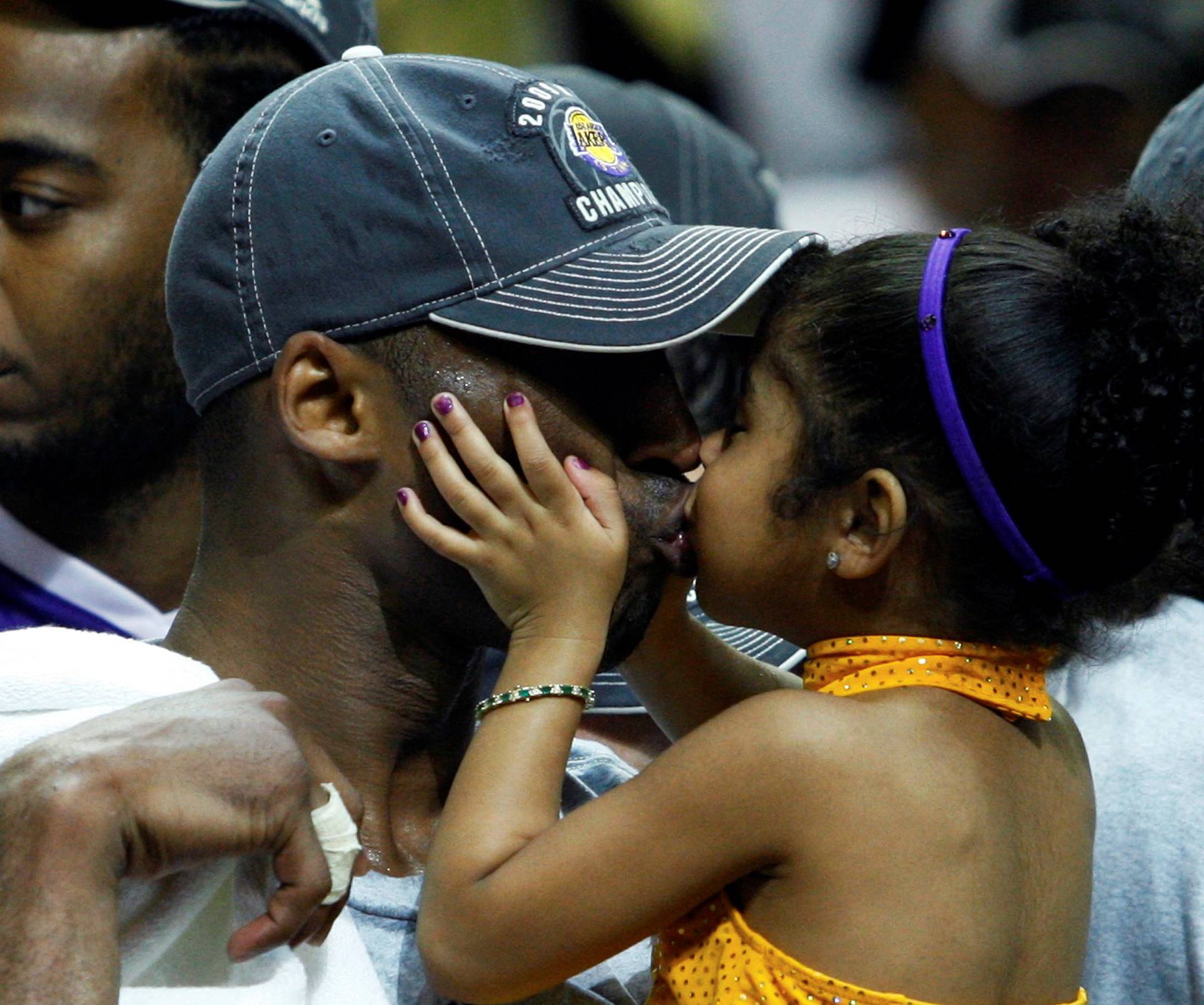 FILE PHOTO: Los Angeles Lakers Kobe Bryant kisses his daughter Gianna after they defeated the Orlando Magic to win the NBA basketball championship in Orlando