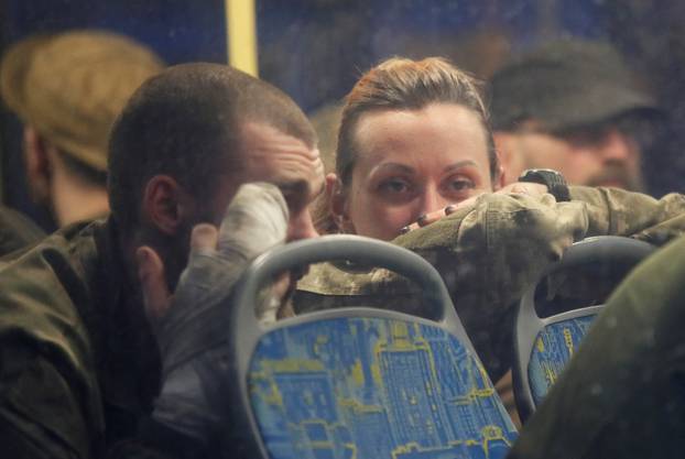 Buses carrying service members of Ukrainian forces who have surrendered after weeks holed up at Azovstal steel works arrive in Olenivka