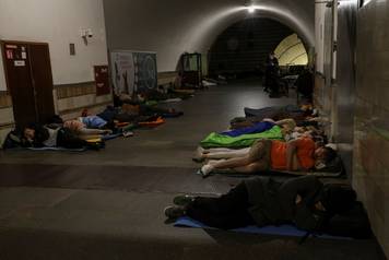 People take shelter inside a metro station during a Russian drone and missile strike in Kyiv