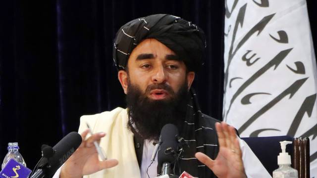 Taliban spokesman Zabihullah Mujahid speaks during a news conference in Kabul