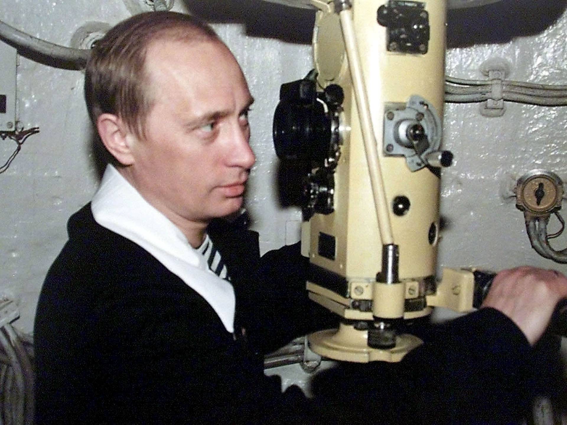 FILE PHOTO: Russia's President Vladimir Putin looking through the periscope of a Karelia submarine in Vidyaevo