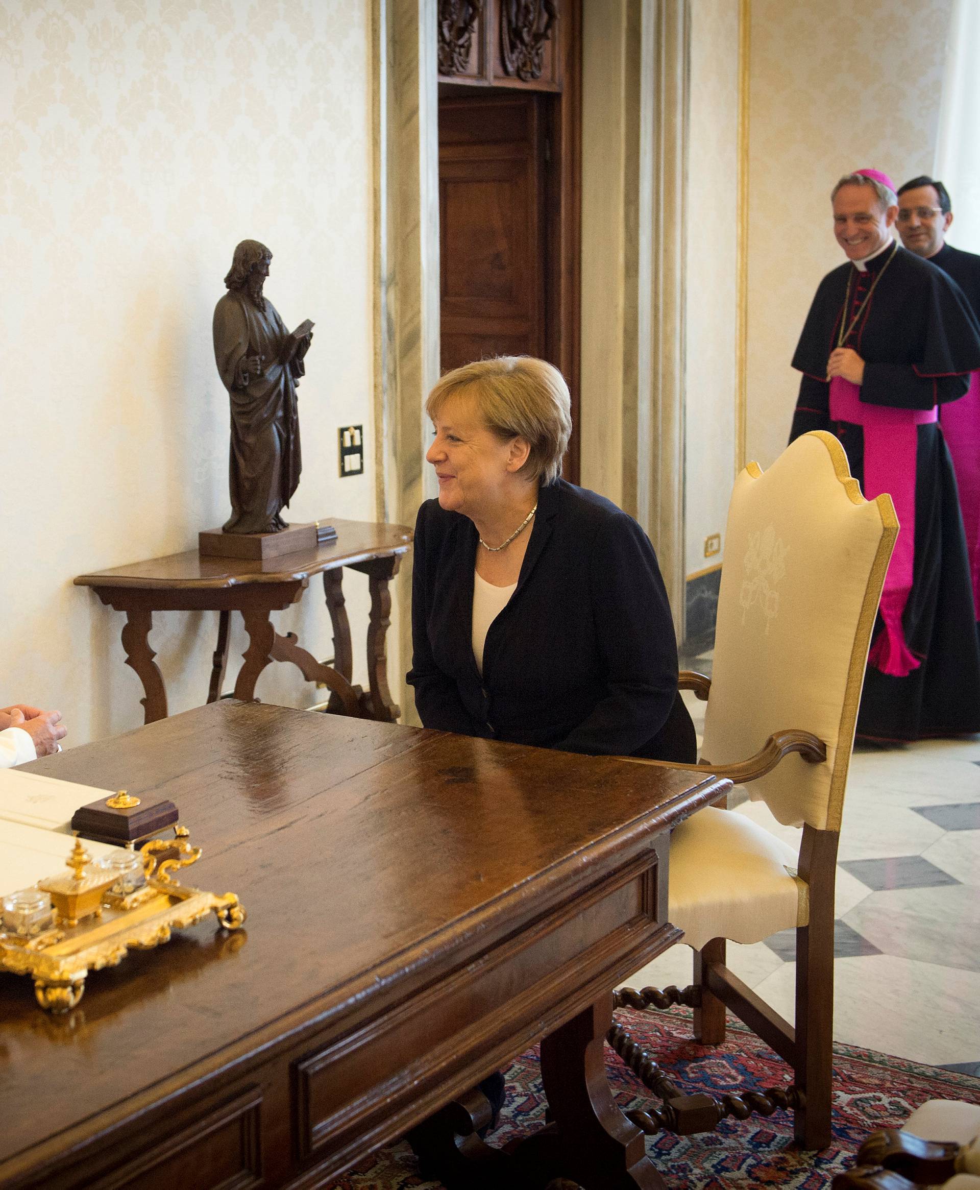 German Chancellor Angela Merkel talks with Pope Francis during a meeting at the Vatican
