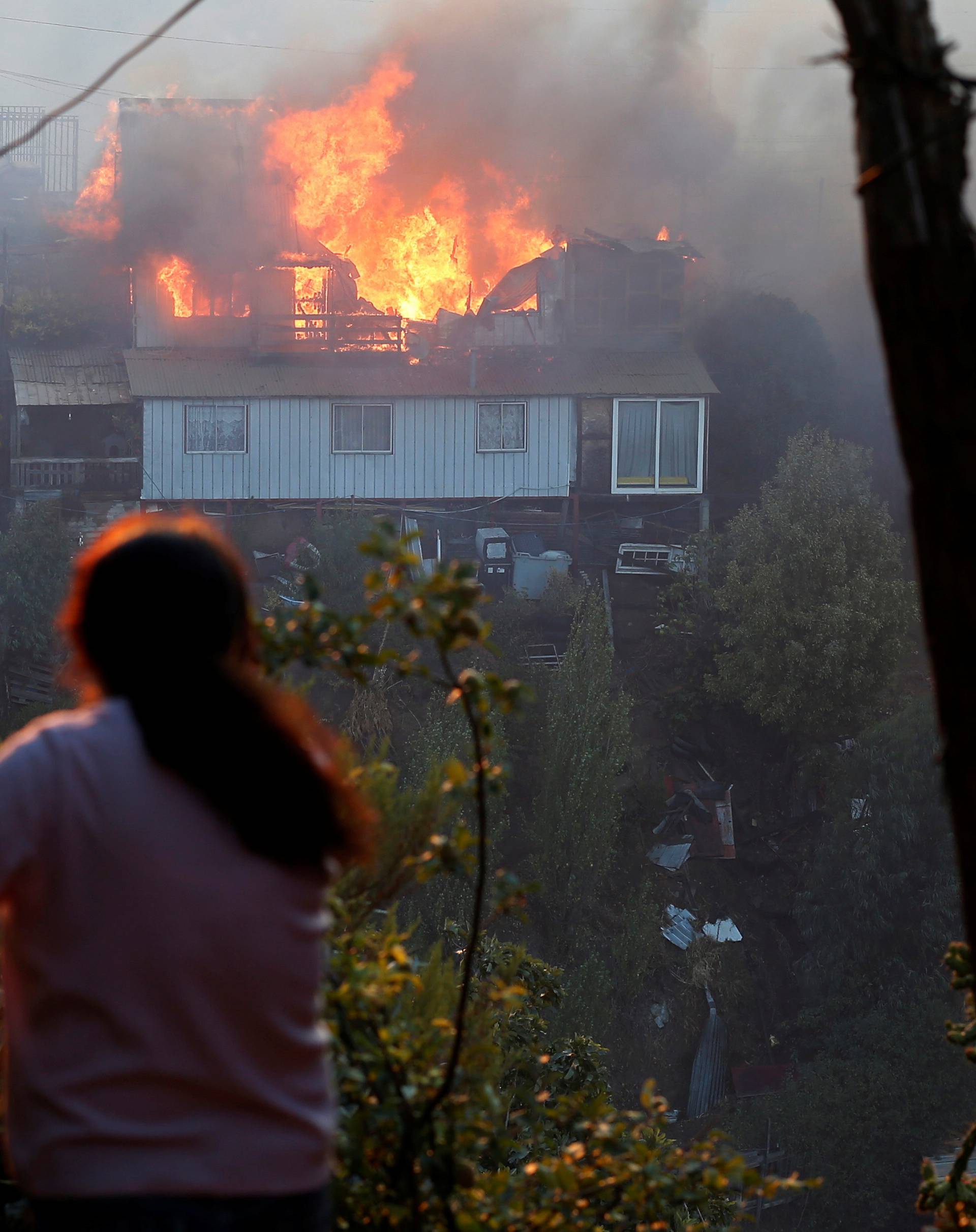 A house burns following the spread of wildfires in Valparaiso