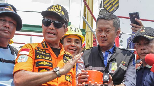 Chief of National Search and Rescue Agency Muhammad Syaugi (L) shows part of the black box of  Lion Air's flight JT610 airplane, on Baruna Jaya ship, in the north sea of Karawang