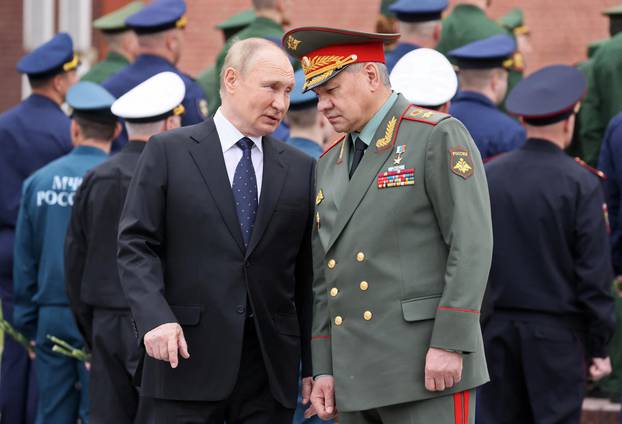 Russian President Vladimir Putin and Defence Minister Sergei Shoigu attend a wreath-laying ceremony in Moscow