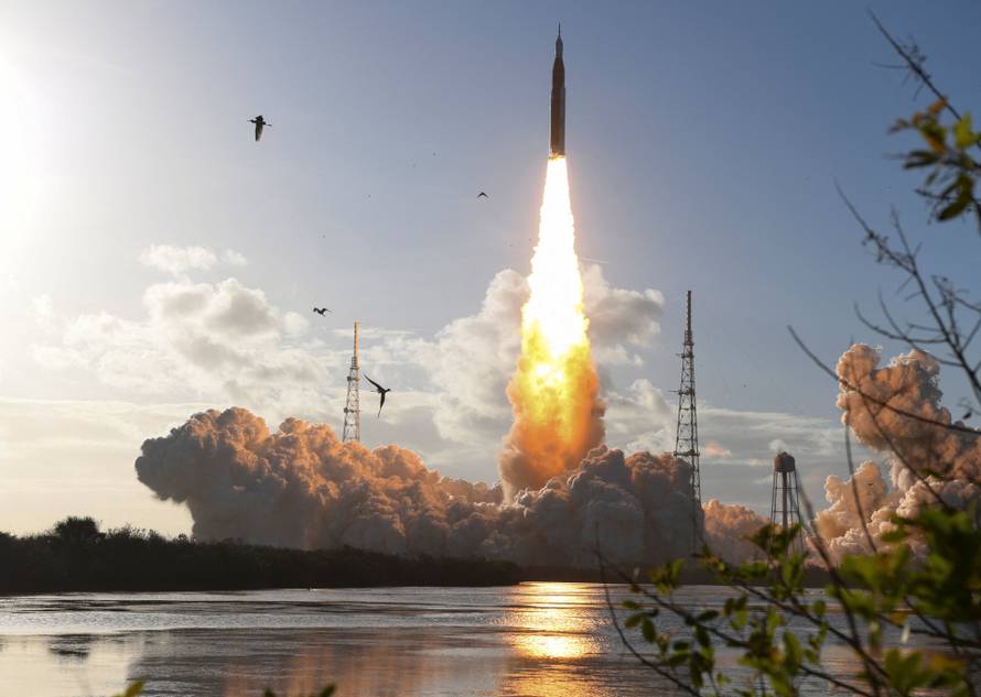NASA's Artemis II mission to fly by the moon, comprising of the Space Launch System (SLS) rocket with the Orion crew capsule, lifts off