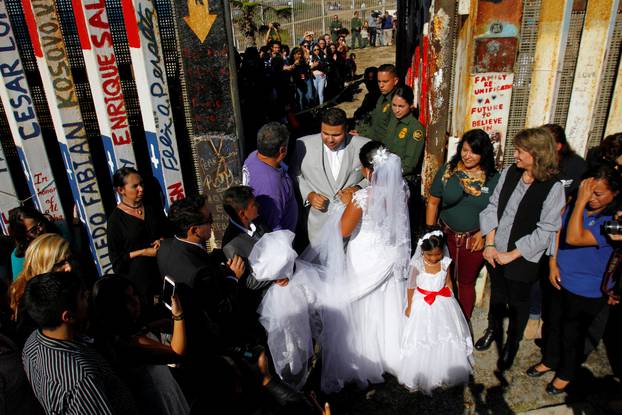 U.S. resident Houston marries Reyes as U.S. Border patrol agents open a single gate to allow families to hug and converse along the Mexico and U.S border in Tijuana