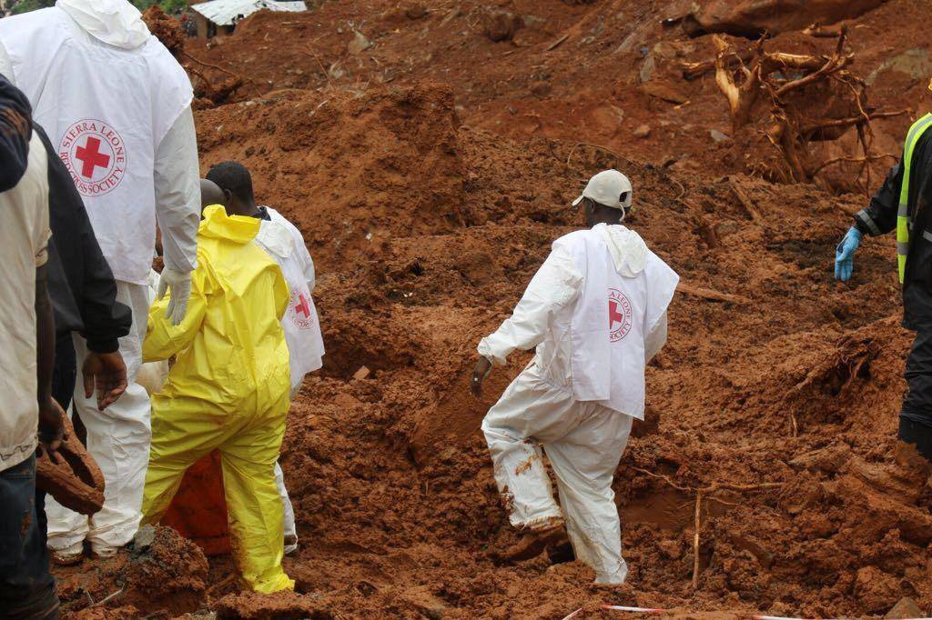 Rescue workers search for survivors after a mudslide in the Mountain town of Regent, Sierra Leone