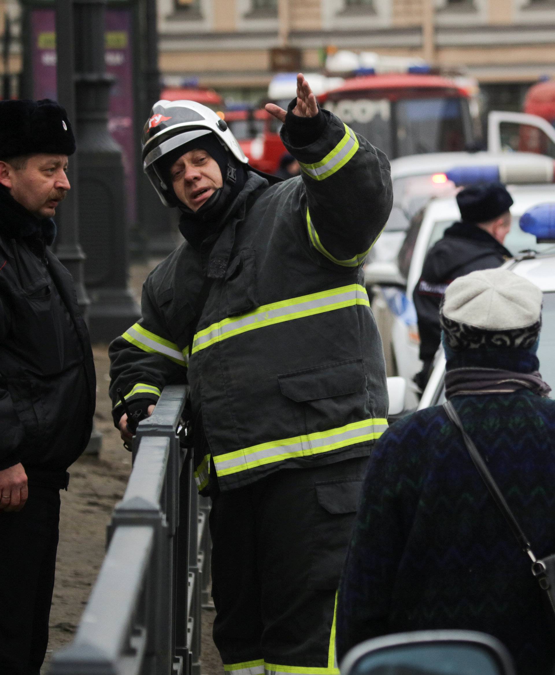 Emergency services direct pedestrians outside Sennaya Ploshchad metro station following explosions in St. Petersburg