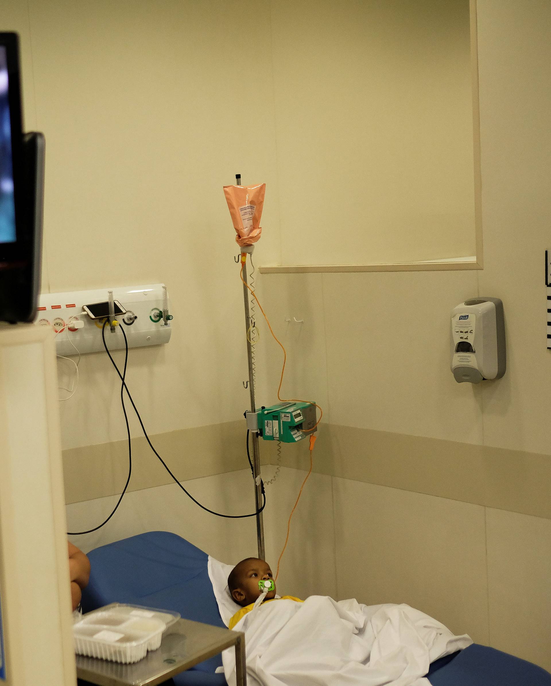 Brazilian patient Lucas wears a Brazil national soccer team t-shirt as he watches Neymar goal against Mexico at the Cancer Itaci Hospital in Sao Paulo