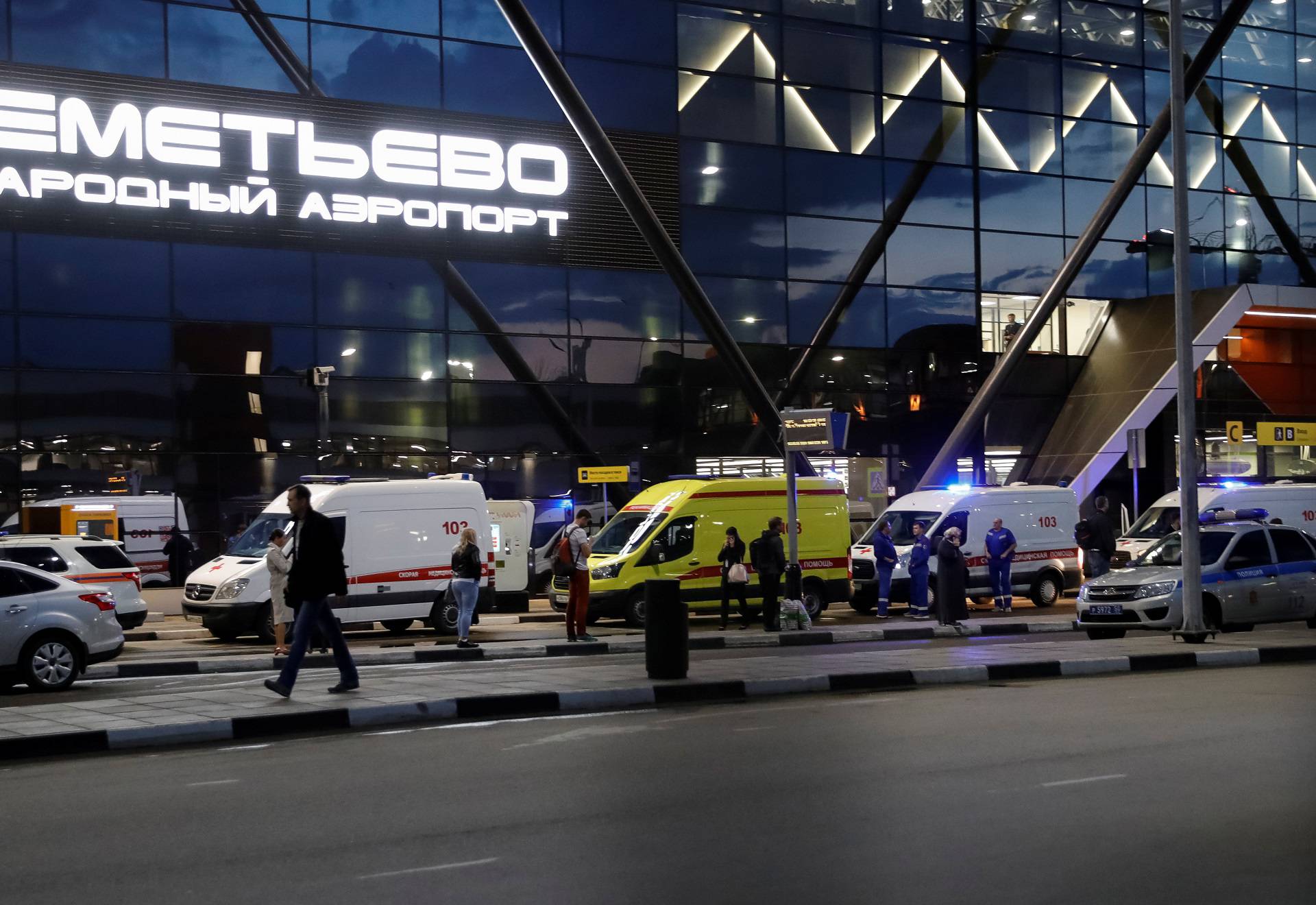 Ambulances wait in front of the terminal building after a passenger plane made an emergency landing at the Sheremetyevo Airport outside Moscow