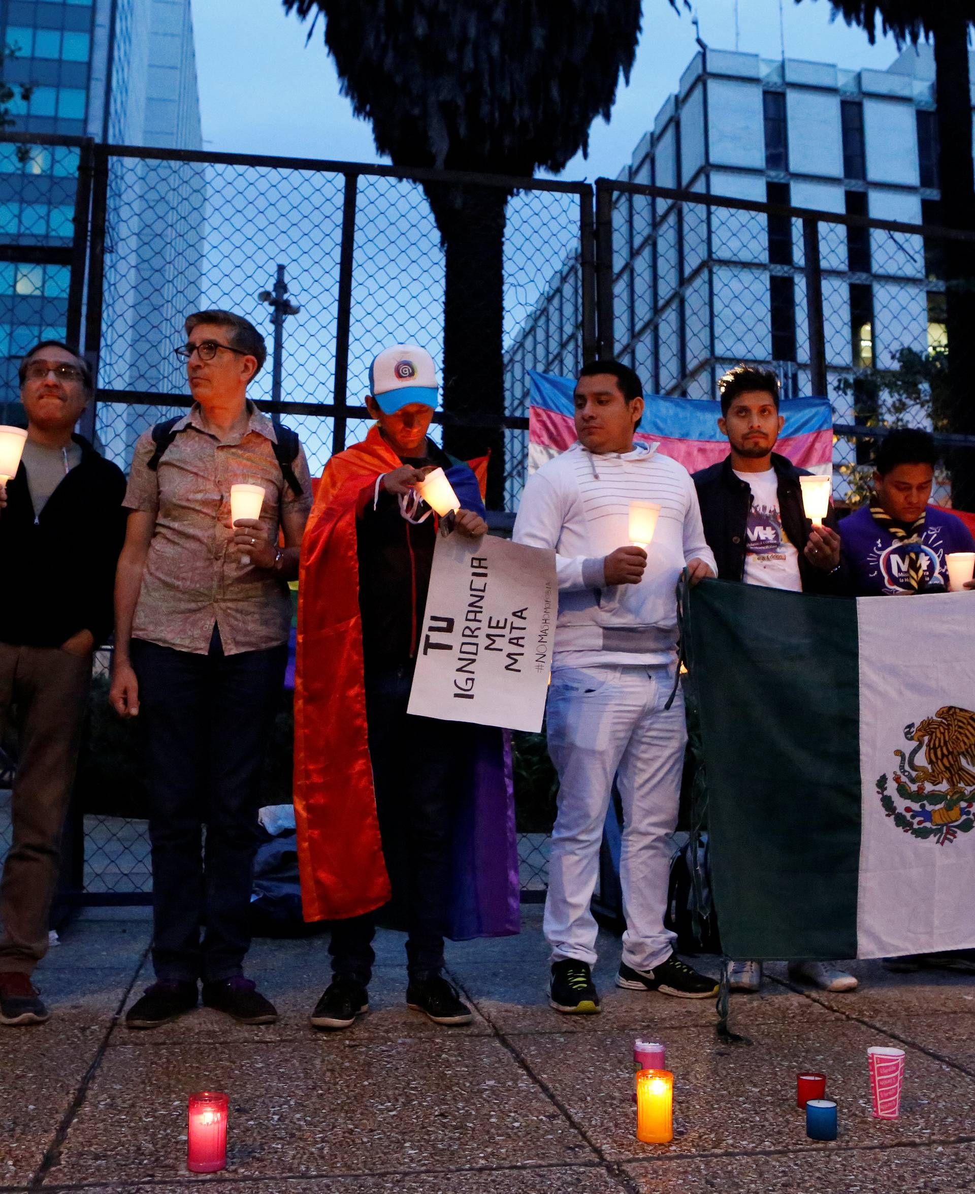 Members of the LGBT community take part in a vigil for the victims of a mass shooting at a gay nightclub in Orlando, Florida, outside the U.S. embassy in Mexico City