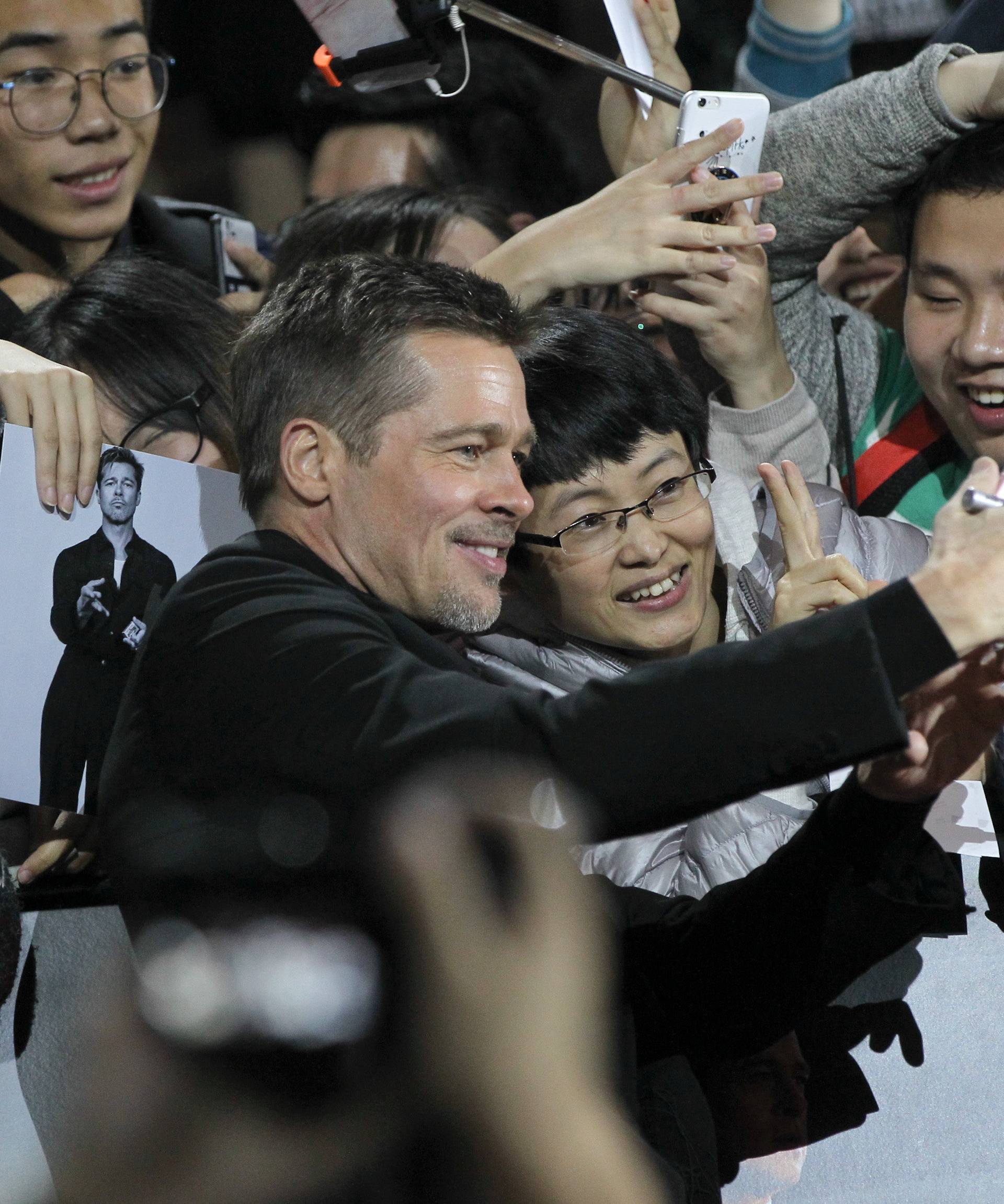 Actor Brad Pitt attends a promotional event for the movie Allied in Shanghai