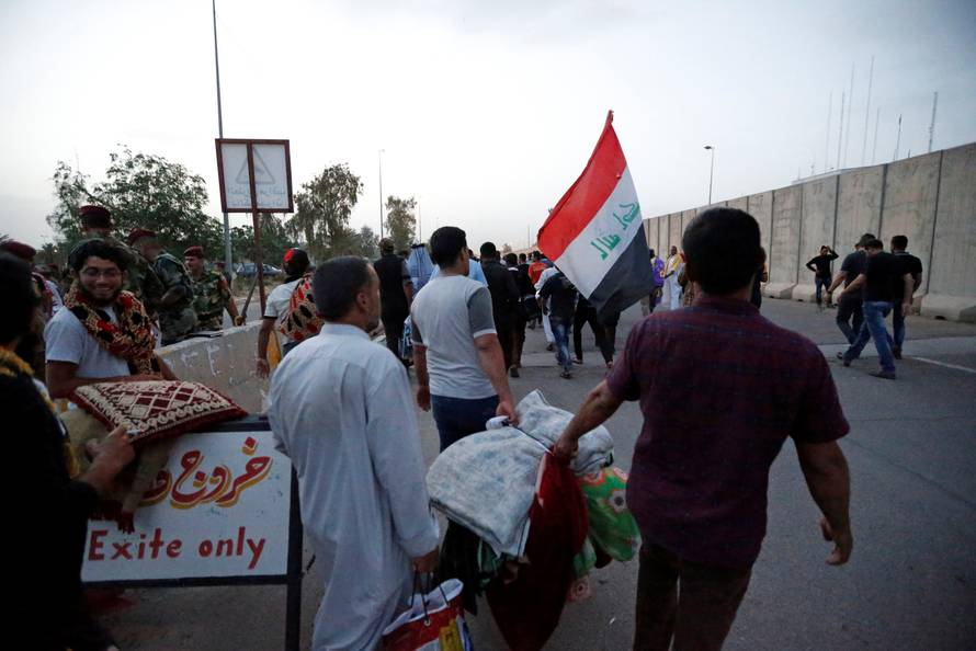 Followers of Iraqi Shi'ite cleric Moqtada al-Sadr leave the Green Zone in Baghdad