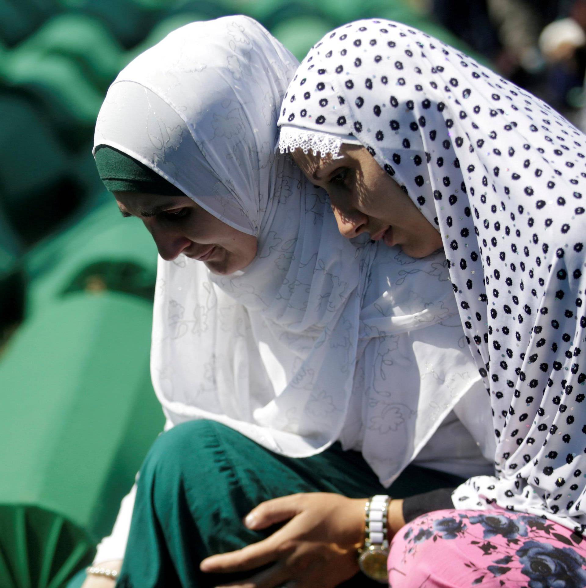 FILE PHOTO: Muslim women cry near coffins of their relatives, who are newly identified victims of the 1995 Srebrenica massacre, which are lined up for a joint burial in Potocari near Srebrenica