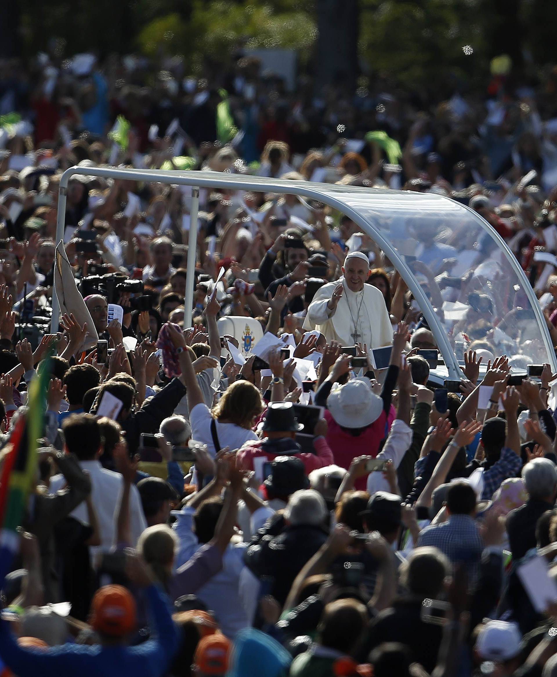 Pope Francis waves as he arrives at the Catholic shrine of Fatima