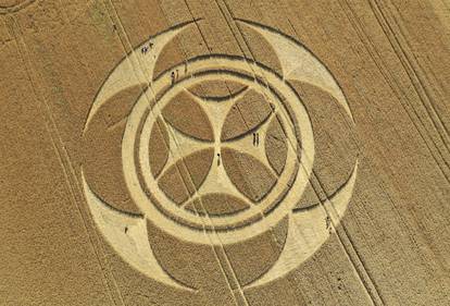 Visitors stand inside a crop circle in a wheat field in Vimy