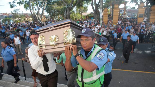 Police officers and relatives carry the coffin of Juana Aguilar, a police officer who died from injury sustained during the protests over a reform to the pension plans of the Nicaraguan Social Security Institute, toward the church in Jinotepe