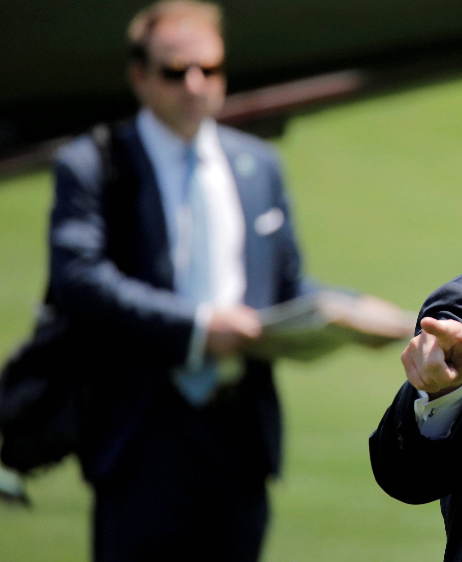 U.S. President Donald Trump gesticulates as he returns from a trip to trip to Annapolis, Maryland, in Washington, U.S.