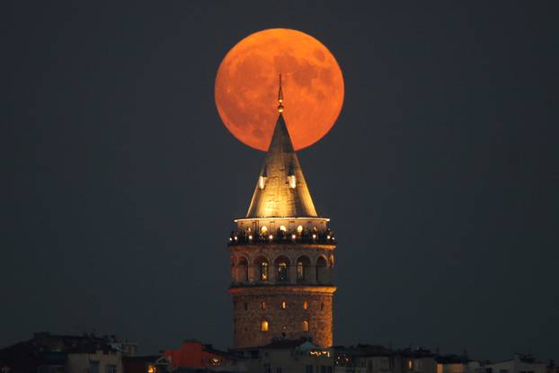 Full moon rises behind the Galata Tower in Istanbul