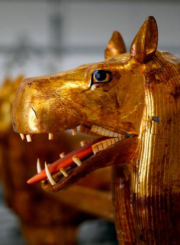 An Egyptian archaeological technician renovates a pharaonic bed with animal figures which belonged to The Golden King Tutankhamun, in the conservation centre of the Grand Egyptian Museum, on the outskirts of Cairo